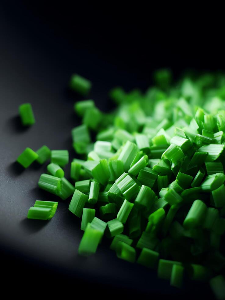 Close up of Freshly Chopped Green Onions on Dark Surface. photo