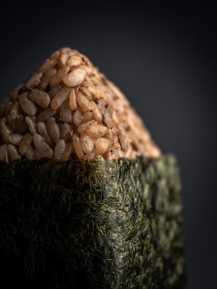 Close up of Brown Rice Onigiri Wrapped in Seaweed. A Detailed Image of Japanese Rice Balls. photo