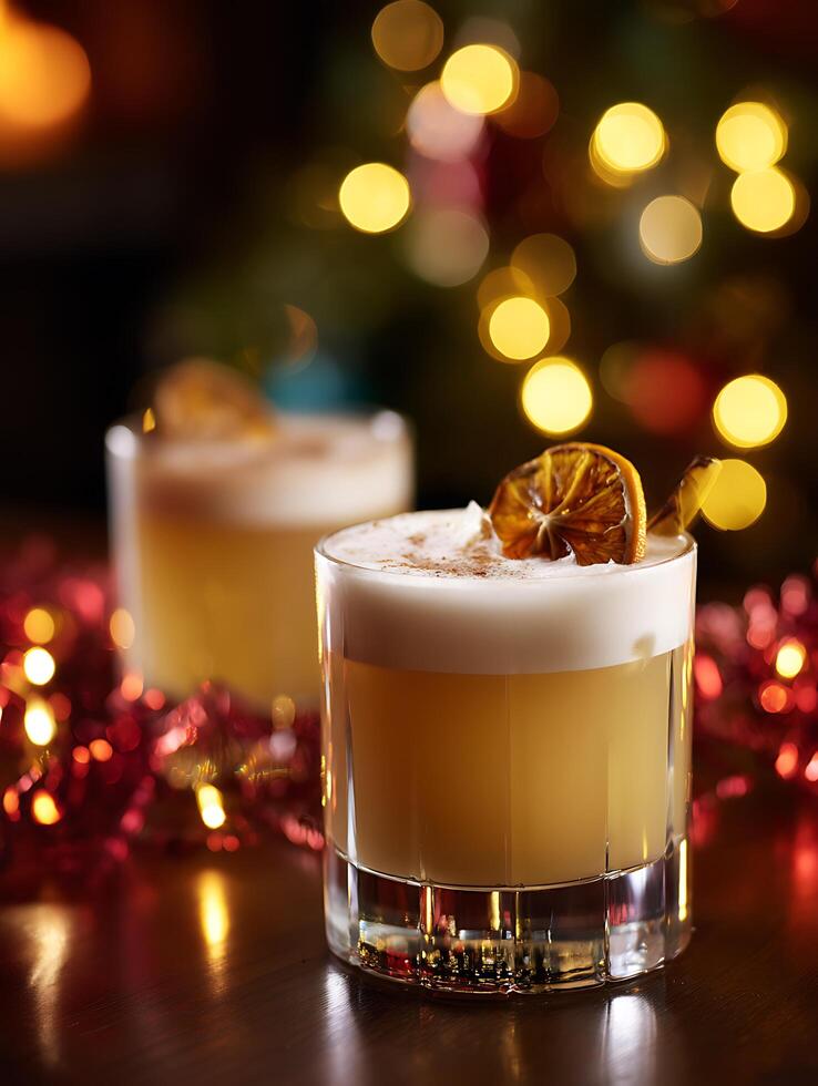Festive Cocktail in a Rocks Glass with Christmas Lights Bokeh. A delicious winter drink garnished with dried orange and cinnamon. photo