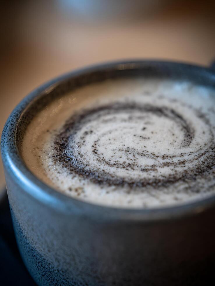 Close up of a Swirled Cappuccino in a Gray Mug. photo
