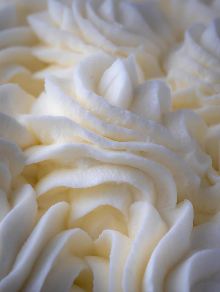 Close Up of Creamy White Frosting Swirls, Delicious Dessert Texture. photo