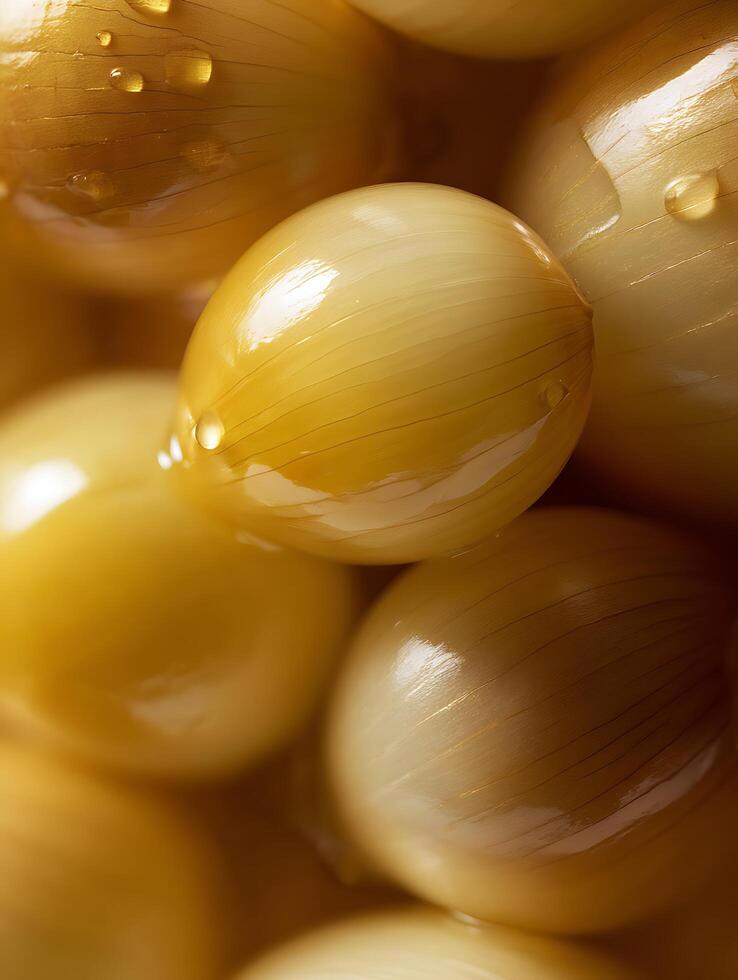 Close Up of Shiny Pickled Pearl Onions, Golden Yellow Hue. photo