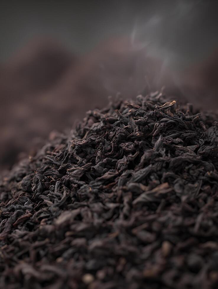 Close Up of Aromatic Dark Tea Leaves with Steam Rising. A detailed image perfect for illustrating articles or packaging related to tea. photo