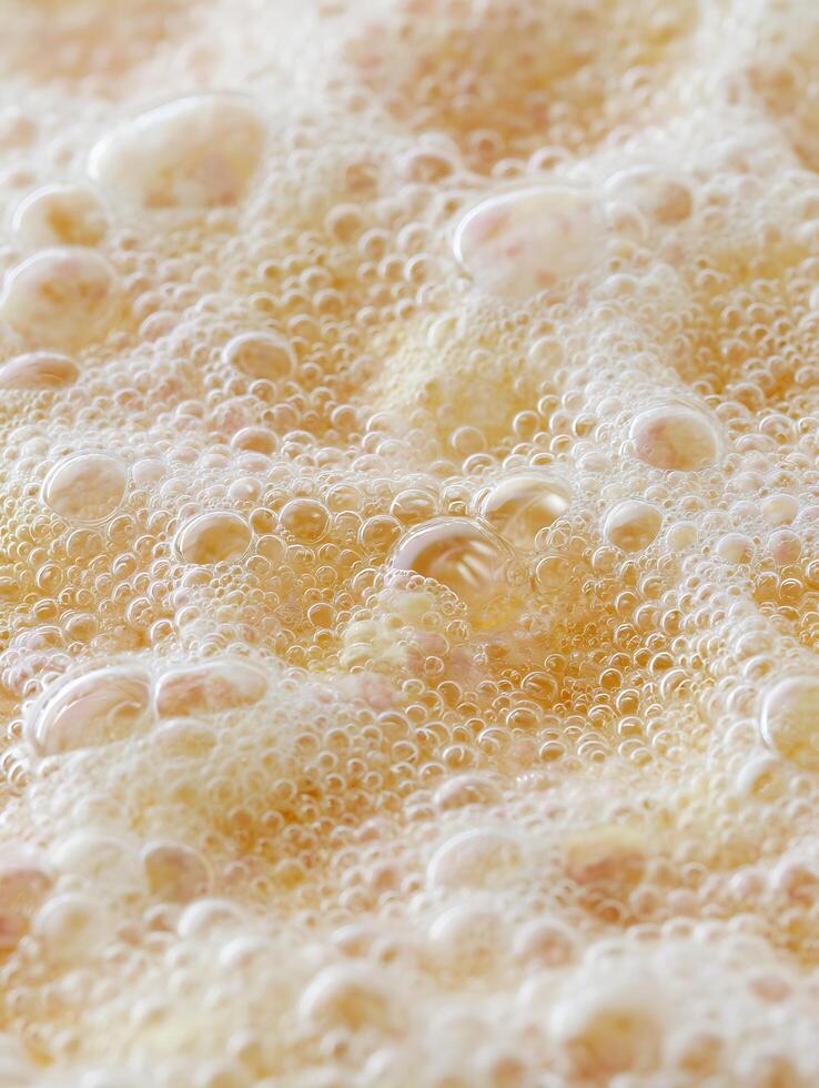 Close Up of Boiling Liquid with Bubbles, Abstract Texture. photo