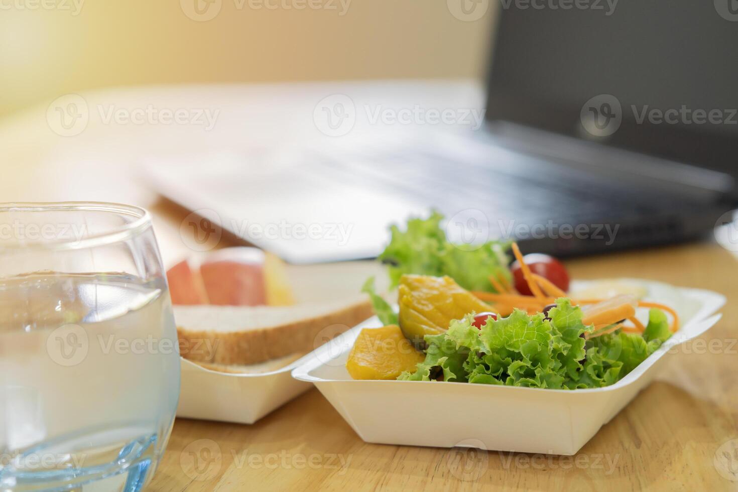 Shot of office worker desk with healthy with mixed fruit and vegan ingredients. photo