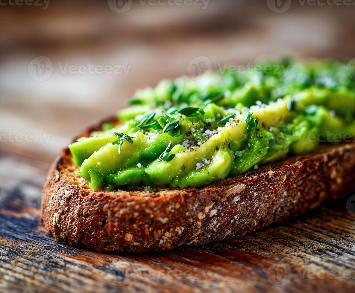 Avocado toast with thyme and salt on a wooden surface photo