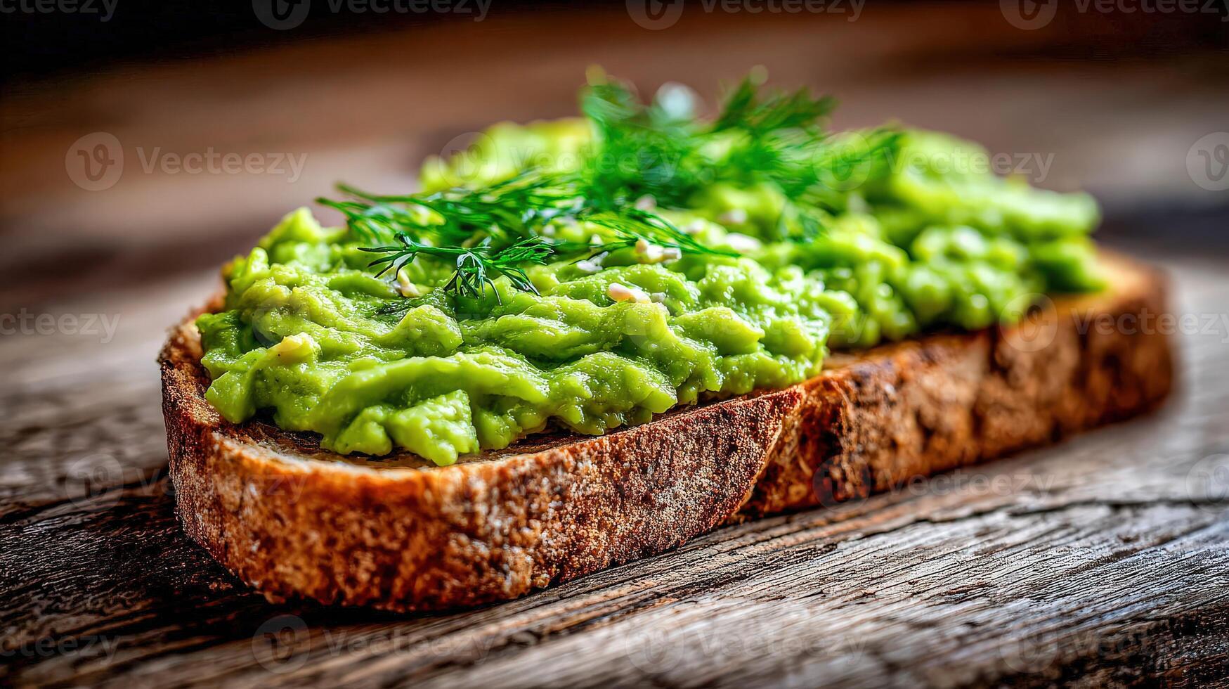 Avocado toast with fresh dill on a wooden surface photo