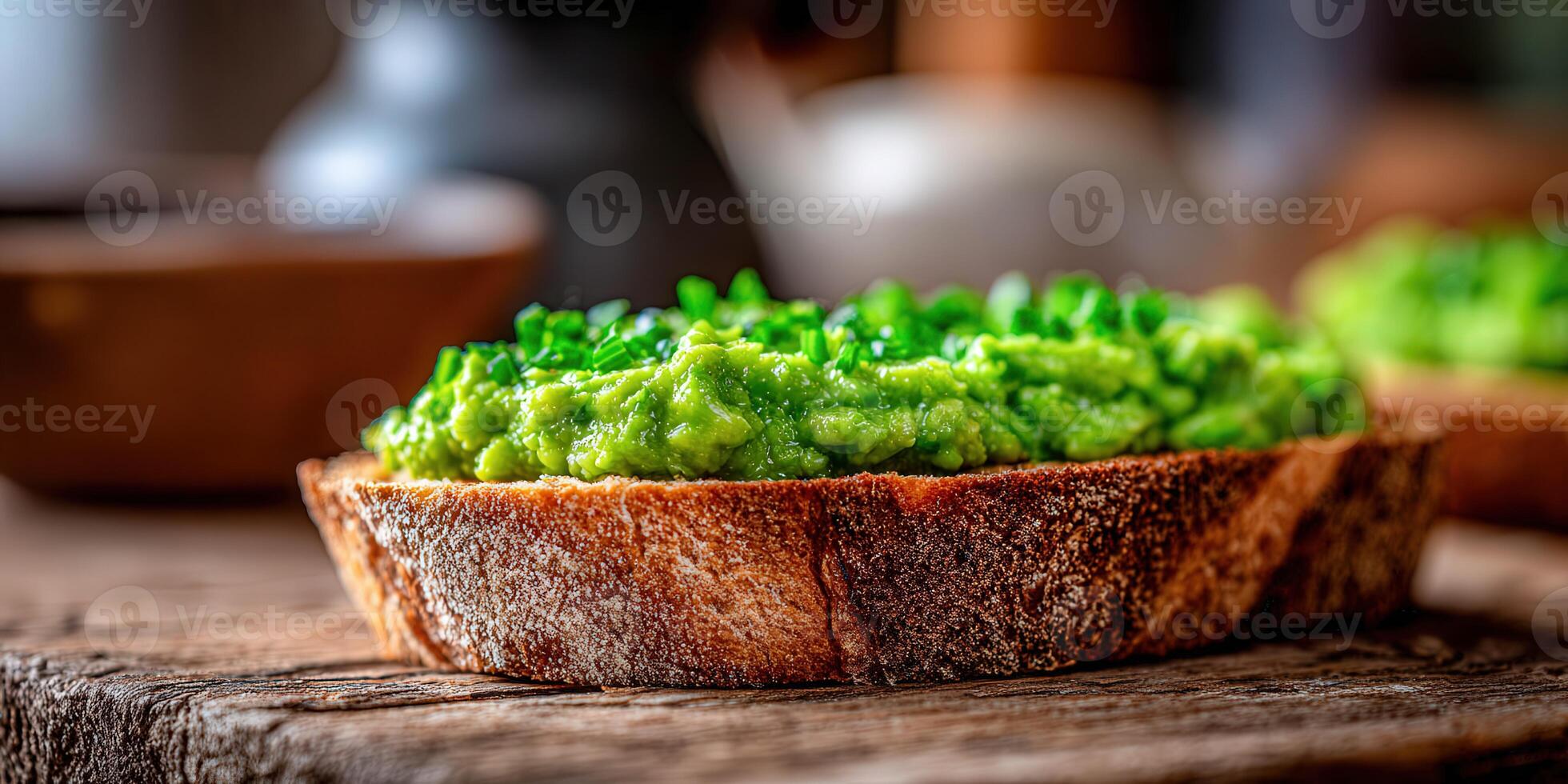 Avocado toast with fresh chives on a wooden cutting board photo