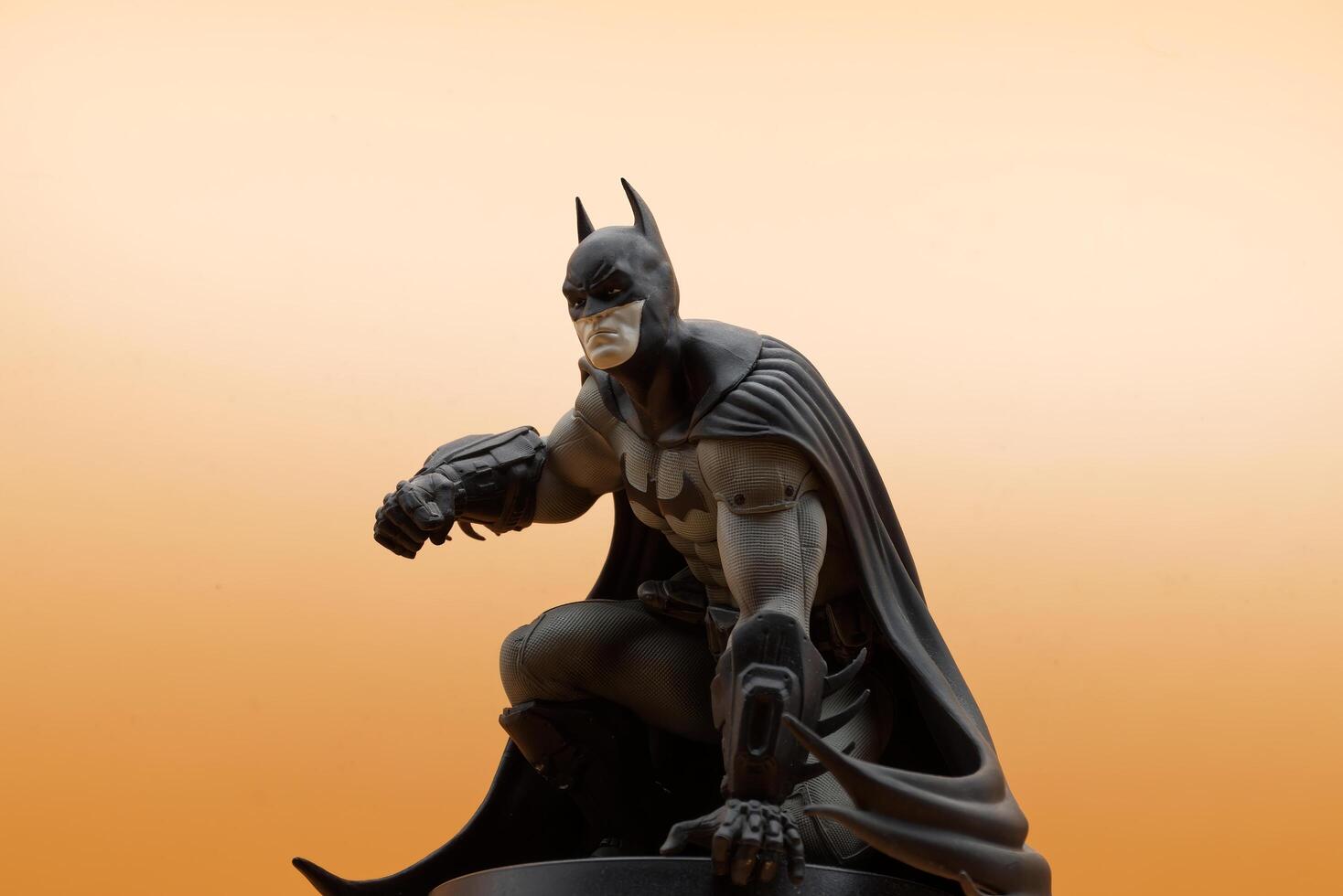 Bologna Italy July 15, 2025 Detailed Batman superhero action figure isolated on an orange background. photo