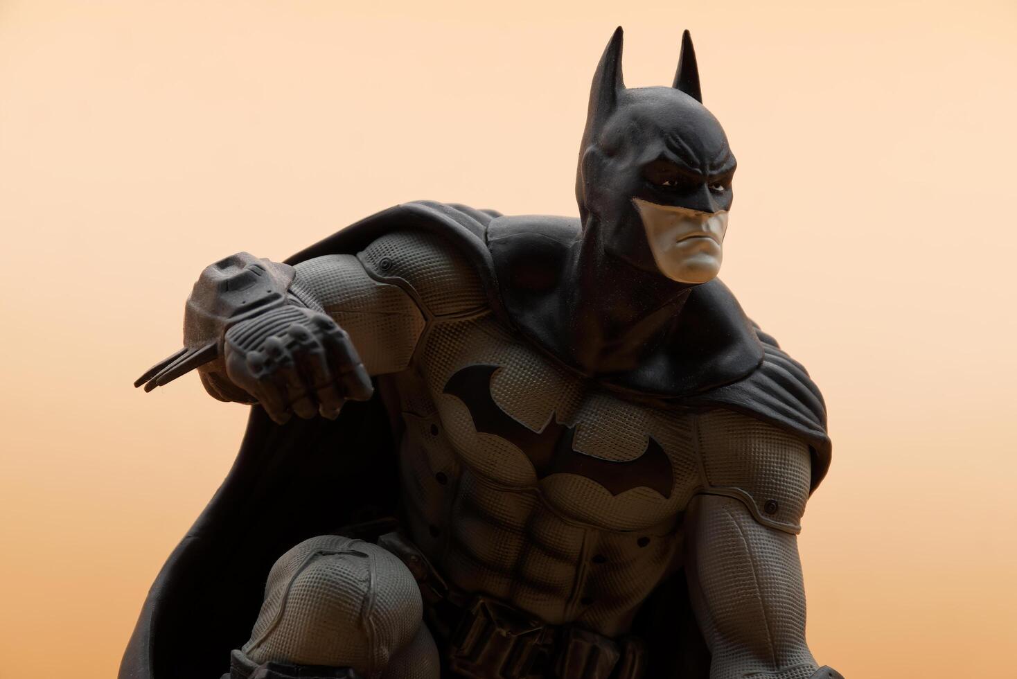 Bologna Italy July 15, 2025 Batman superhero action figure isolated on an orange background. photo