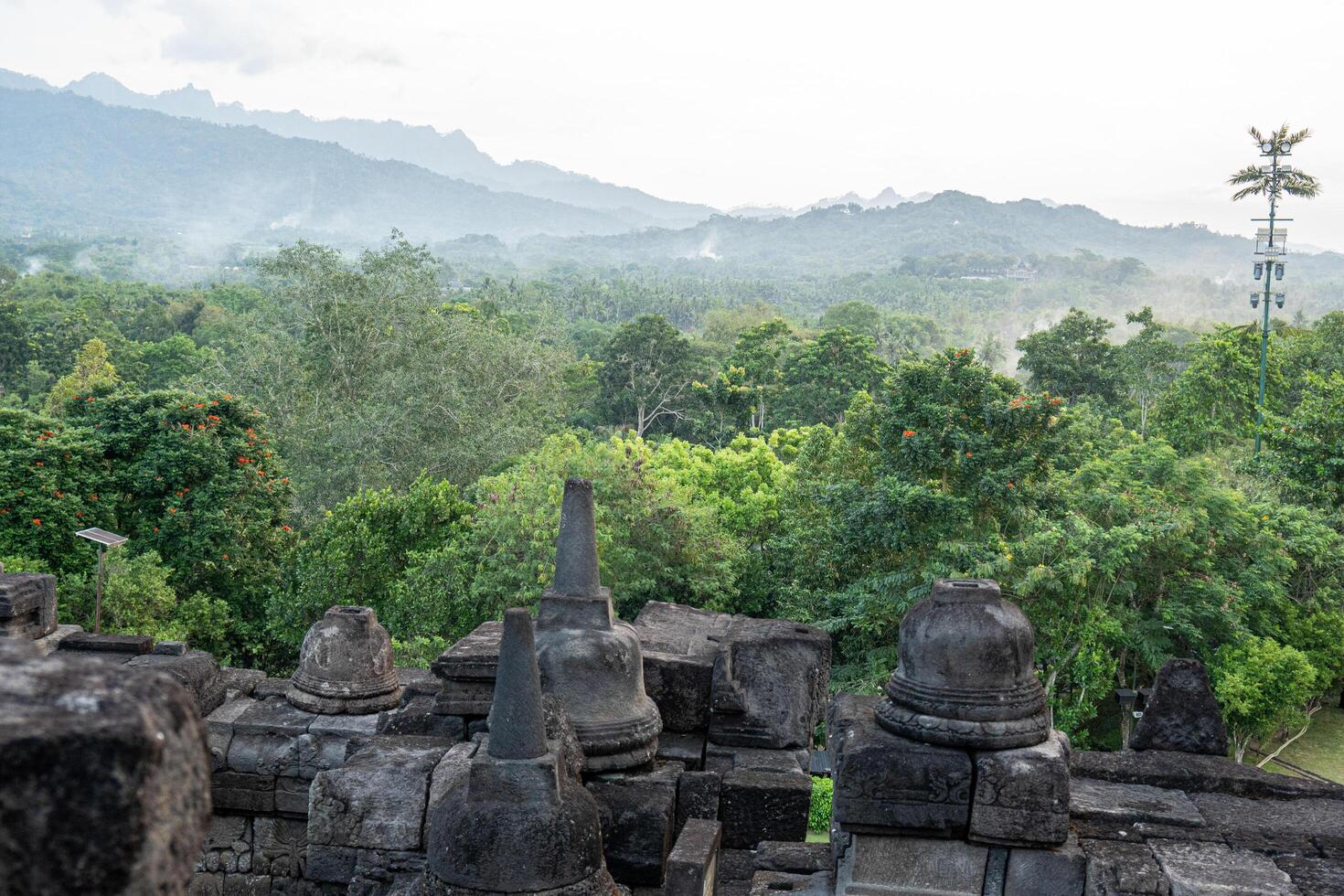 Tranquil Landscape View from Ancient Stone Structure towards Green Forest Mountain photo