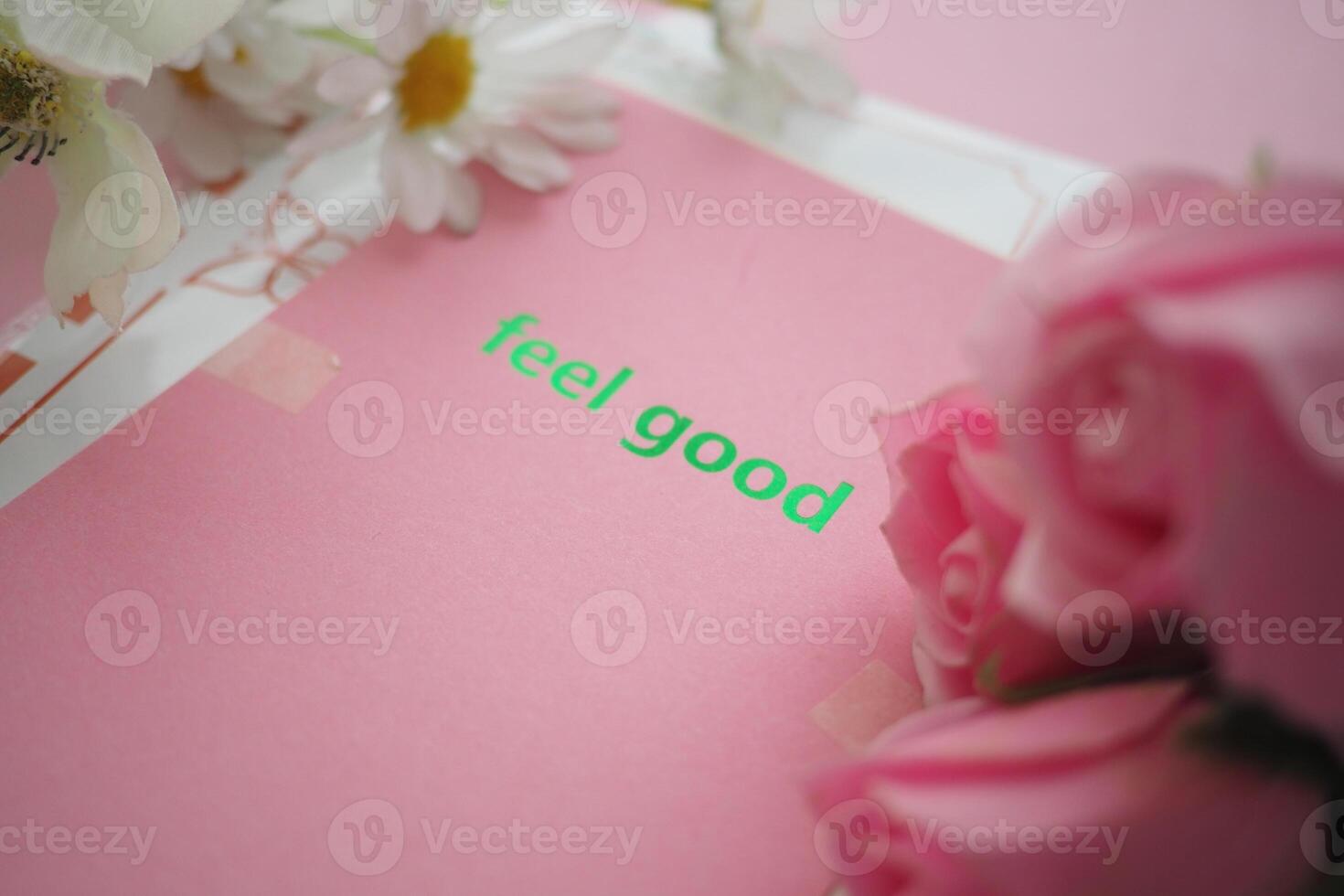 Bright pink card with feel good message and flowers nearby photo