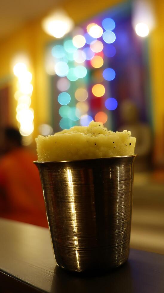 Close up of Creamy Dessert in a Metallic Cup with Bokeh Lights Background. photo