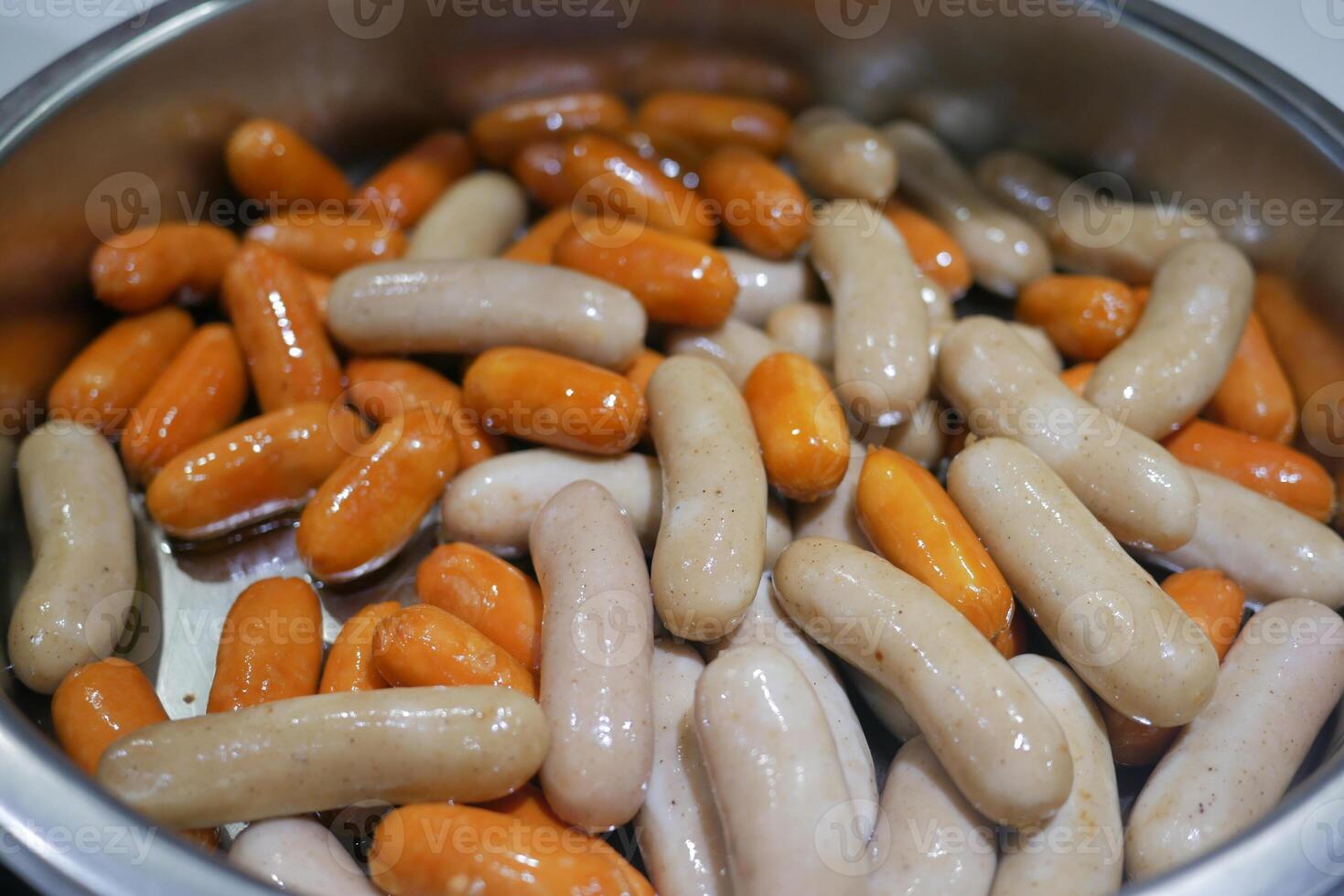 Cooking sausages in a pot for a delicious meal photo