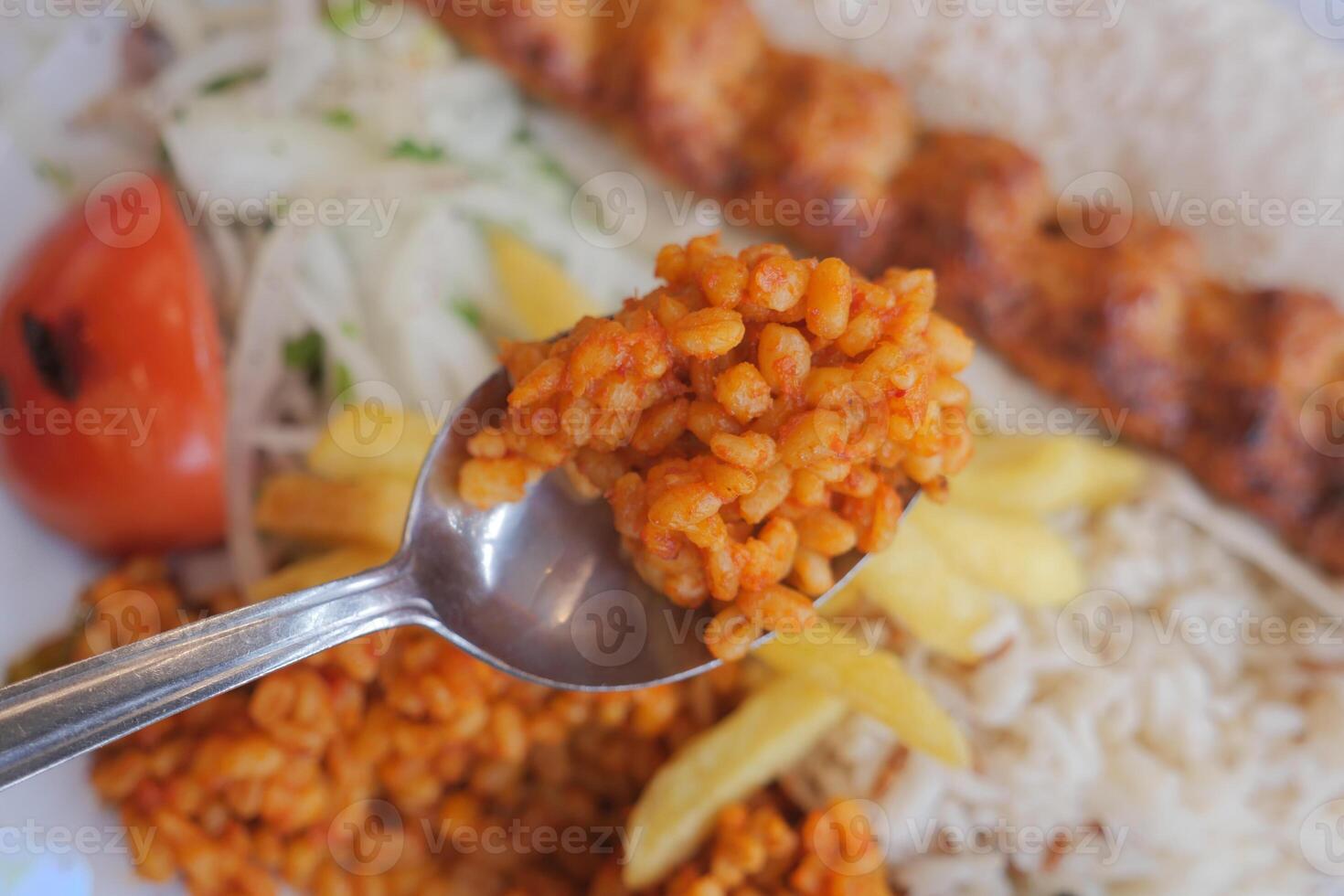Delicious meal featuring rice and kebabs served on a plate photo