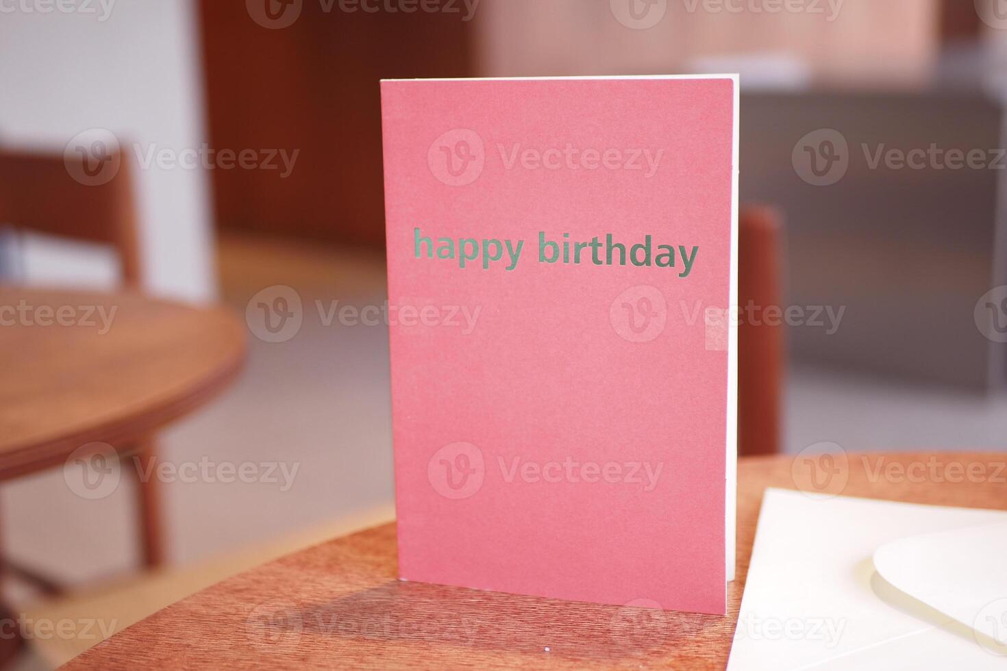 Birthday card displayed on a wooden table in a cozy setting photo