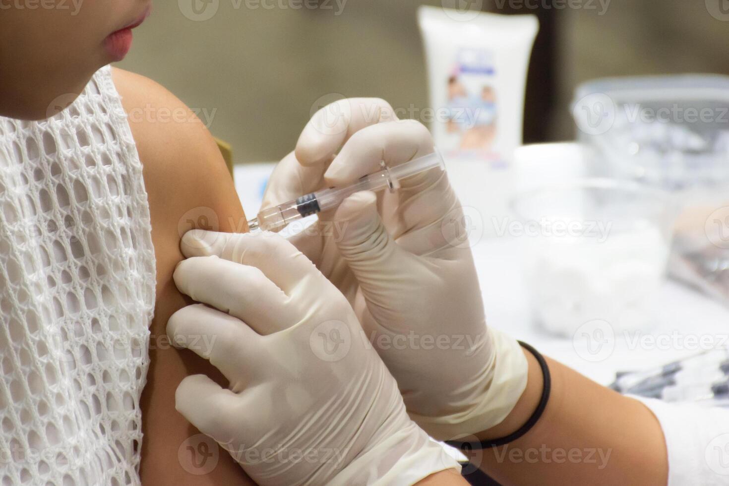 A person getting an injection from a doctor photo