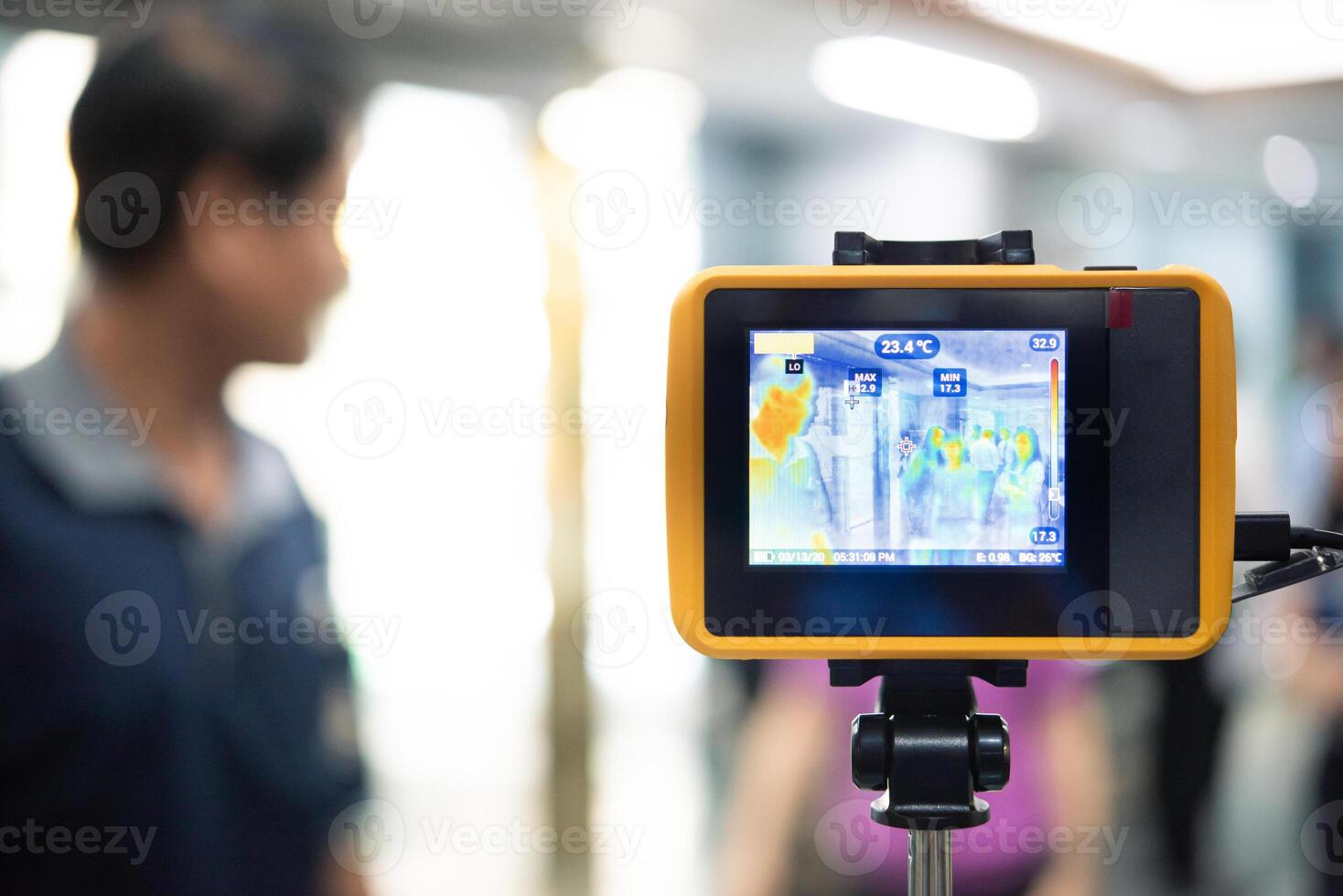 A man is standing in front of a camera photo