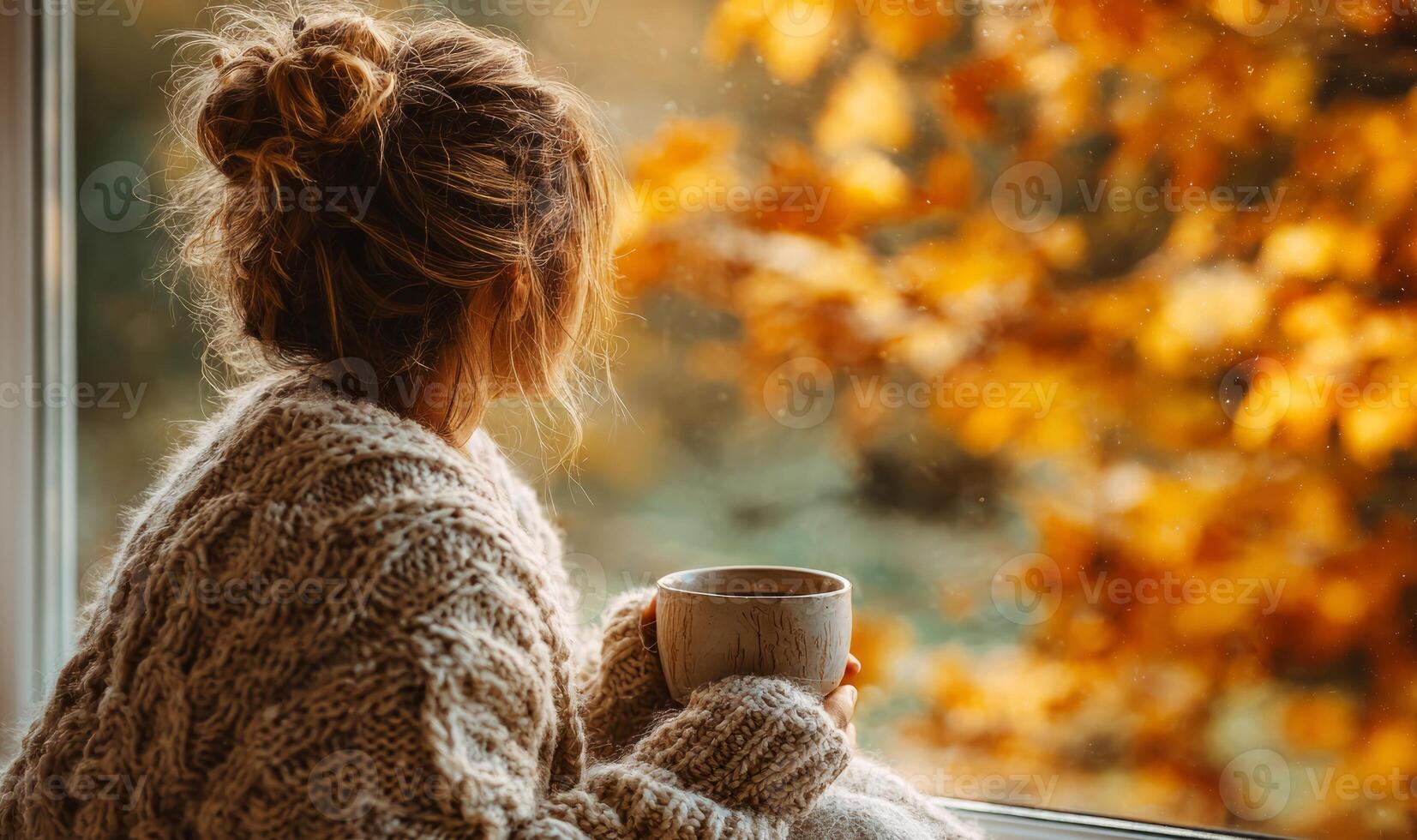 Woman in sweater enjoying autumn view photo