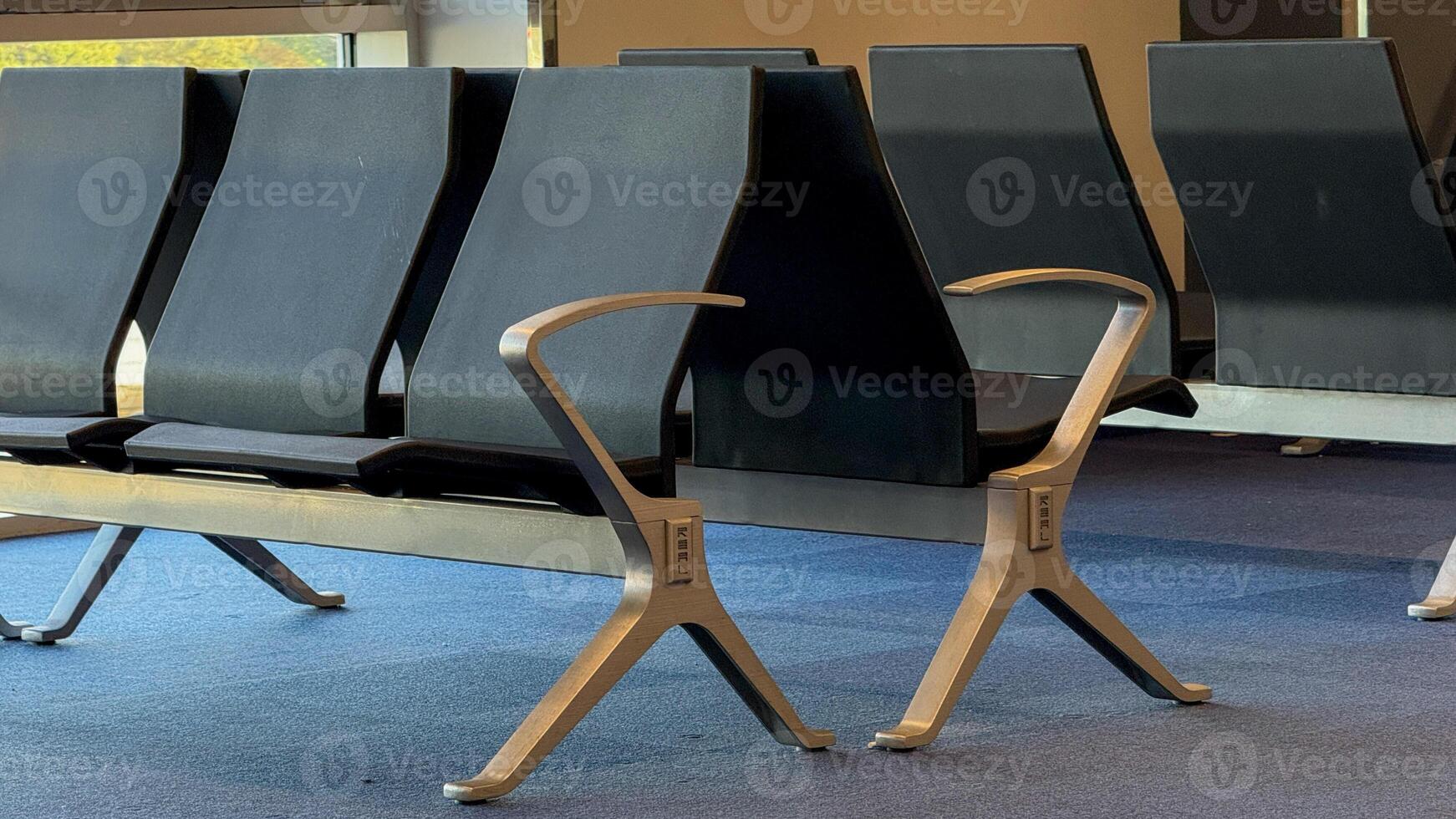 Empty airport seating, sleek solitude of layover lounges, echoes of transient travelers, reminiscent of World Tourism Day anticipation photo