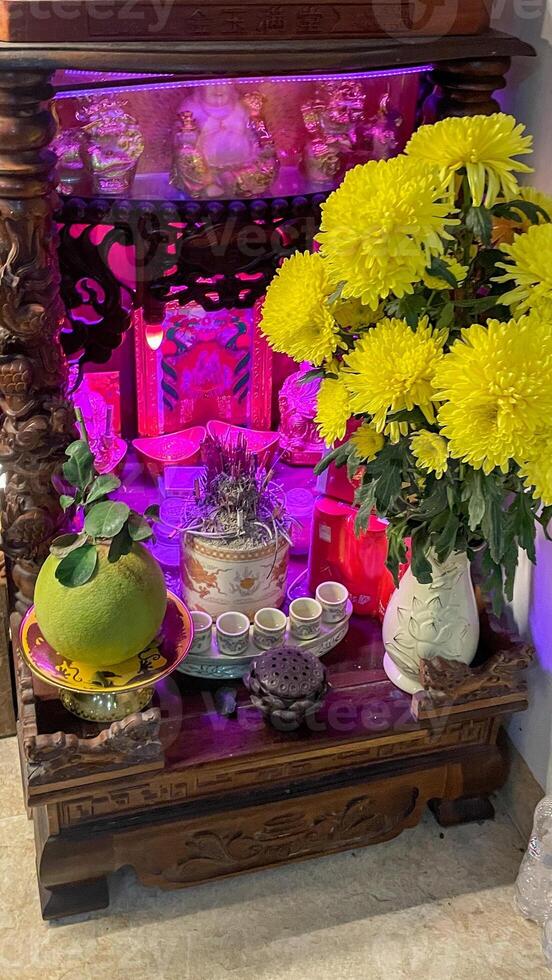 Golden chrysanthemums and offerings dance in vibrant hues, evoking ancestral whispers during Vietnams Vu Lan Festival photo