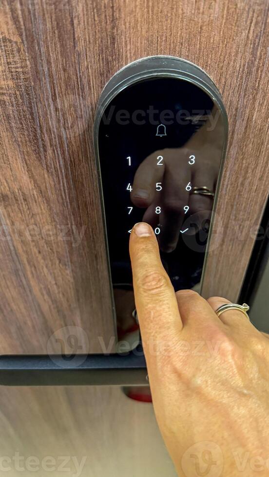 A hand poised on a digital locks keypad, unlocking secrets of future noir, symbolizes Cybersecurity Awareness Month photo