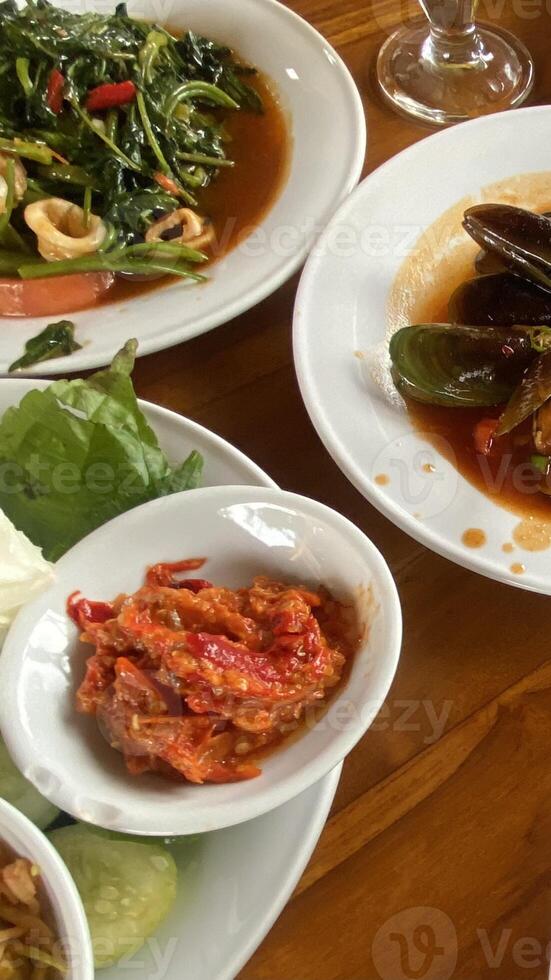 Fresh Indonesian Lalapan Dish with Stir-Fried Water Spinach photo