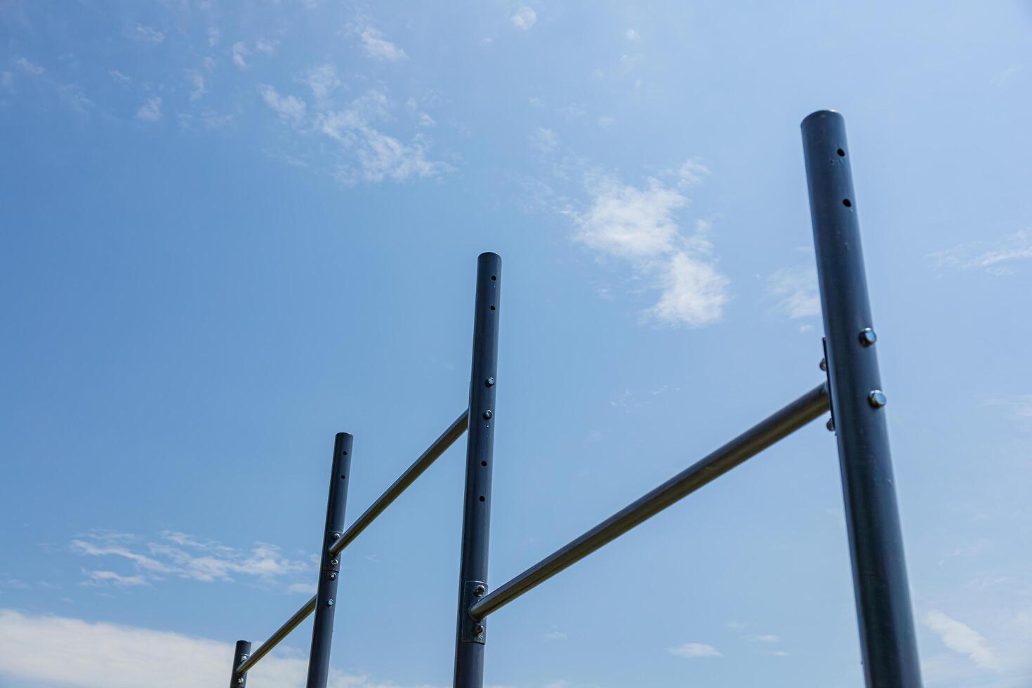 Parallel bars stand in a sunlit gym setting, inviting users to practice exercises for strength and balance in a vibrant outdoor environment photo