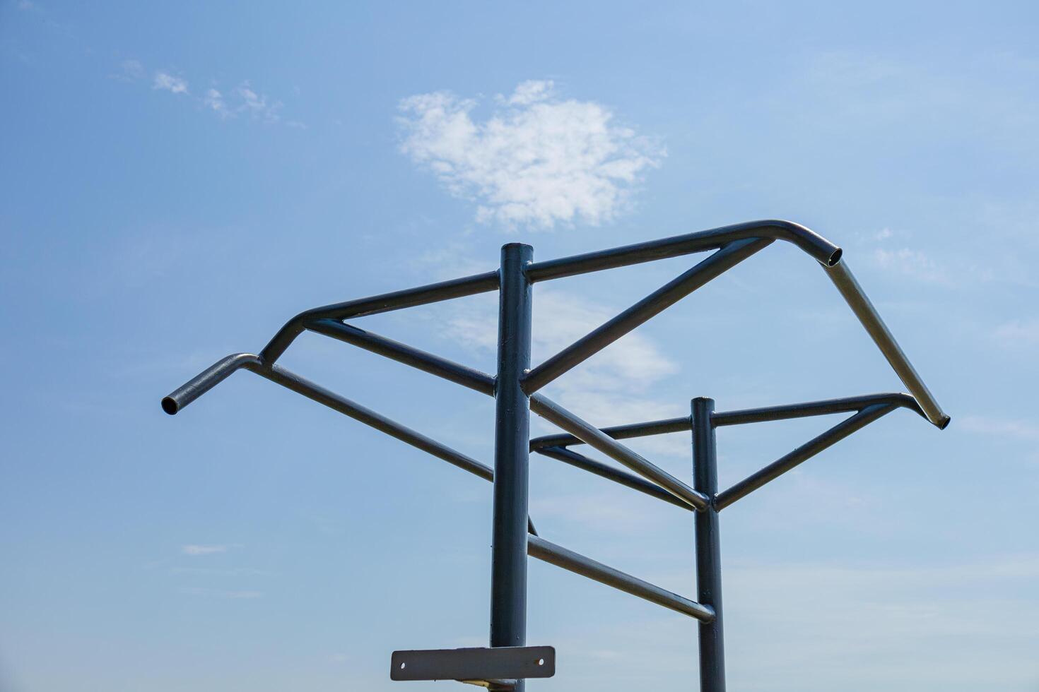 Two parallel horizontal bars stand in an outdoor gym, inviting fitness enthusiasts to engage in strength training activities in the fresh air photo