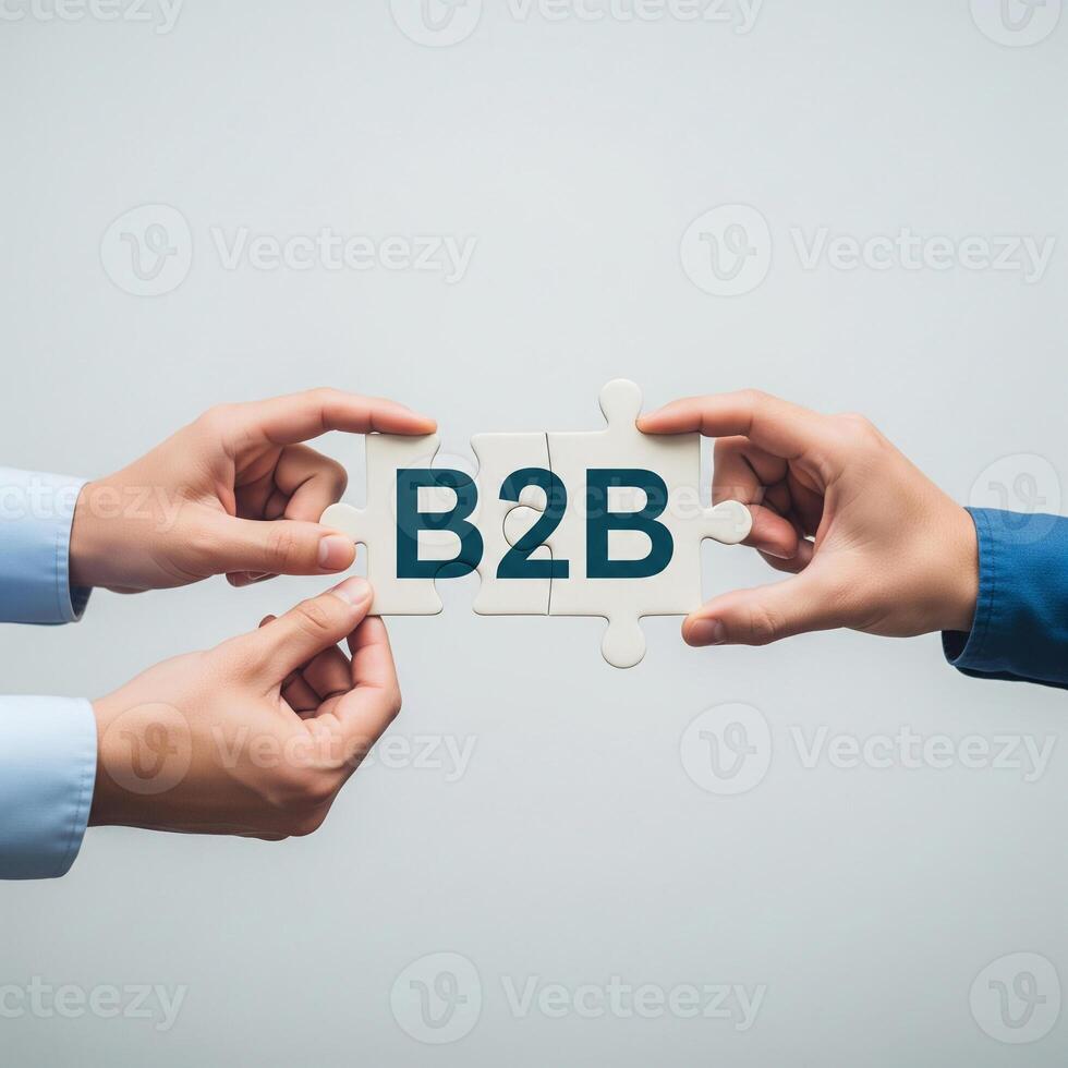 Two hands connect puzzle pieces with the letters b2b symbolizing business partnership photo