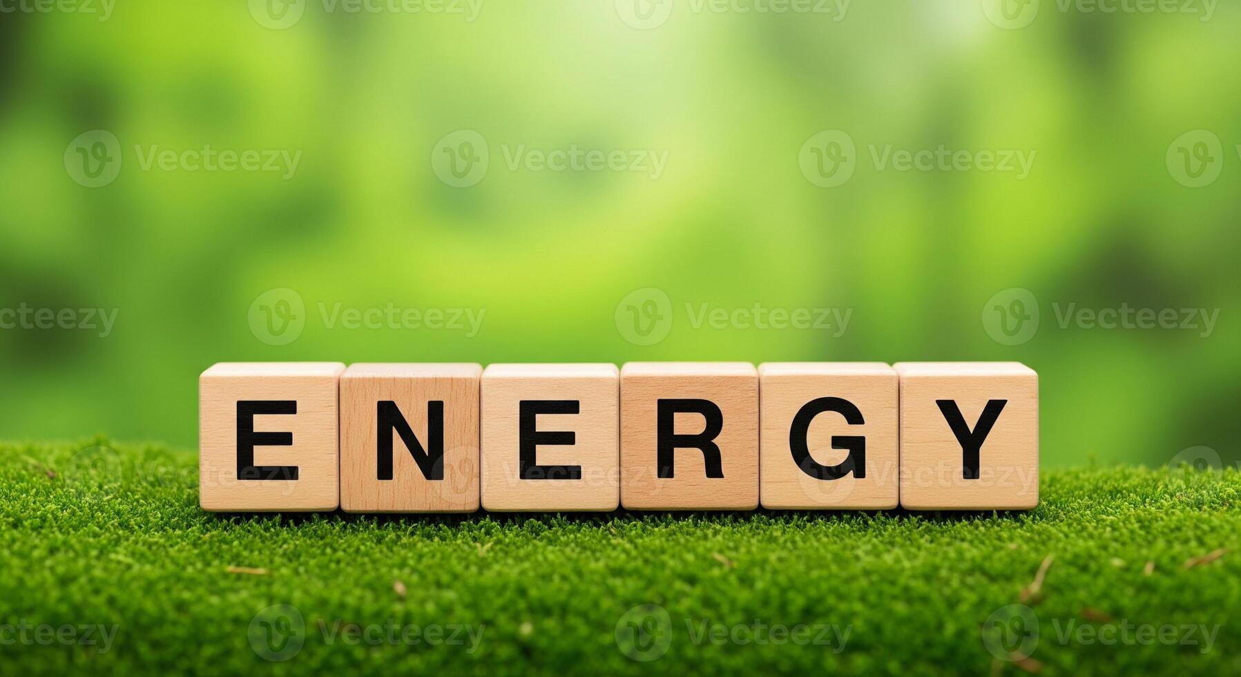 Wooden blocks spell out energy on lush green moss background photo