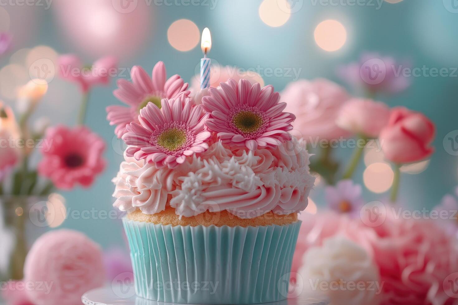Delicious cupcake decorated with pink flowers and lit candle celebrating birthday photo