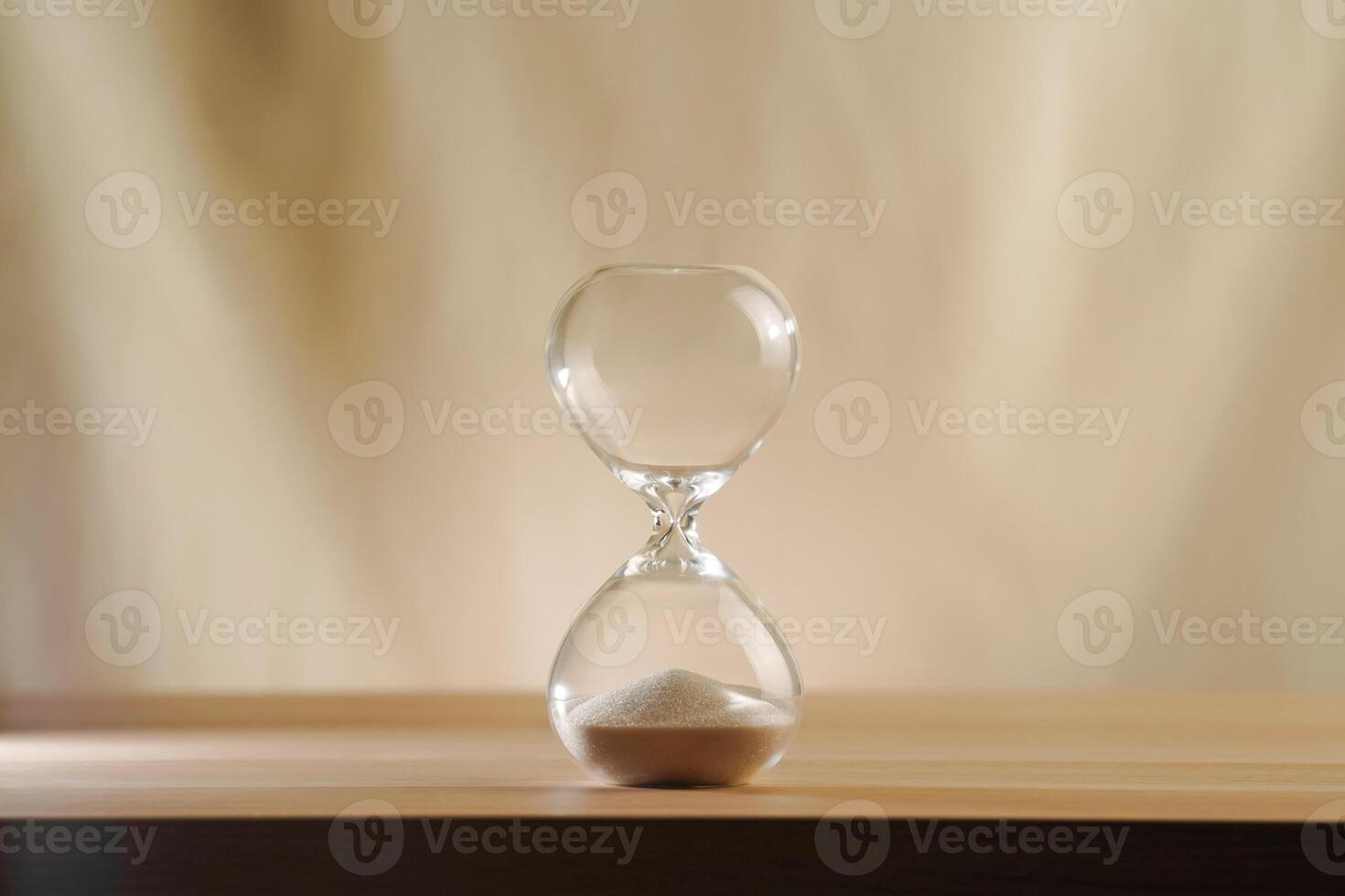 Minimalist Glass time over Hourglass on Wooden Surface with Beige Background photo