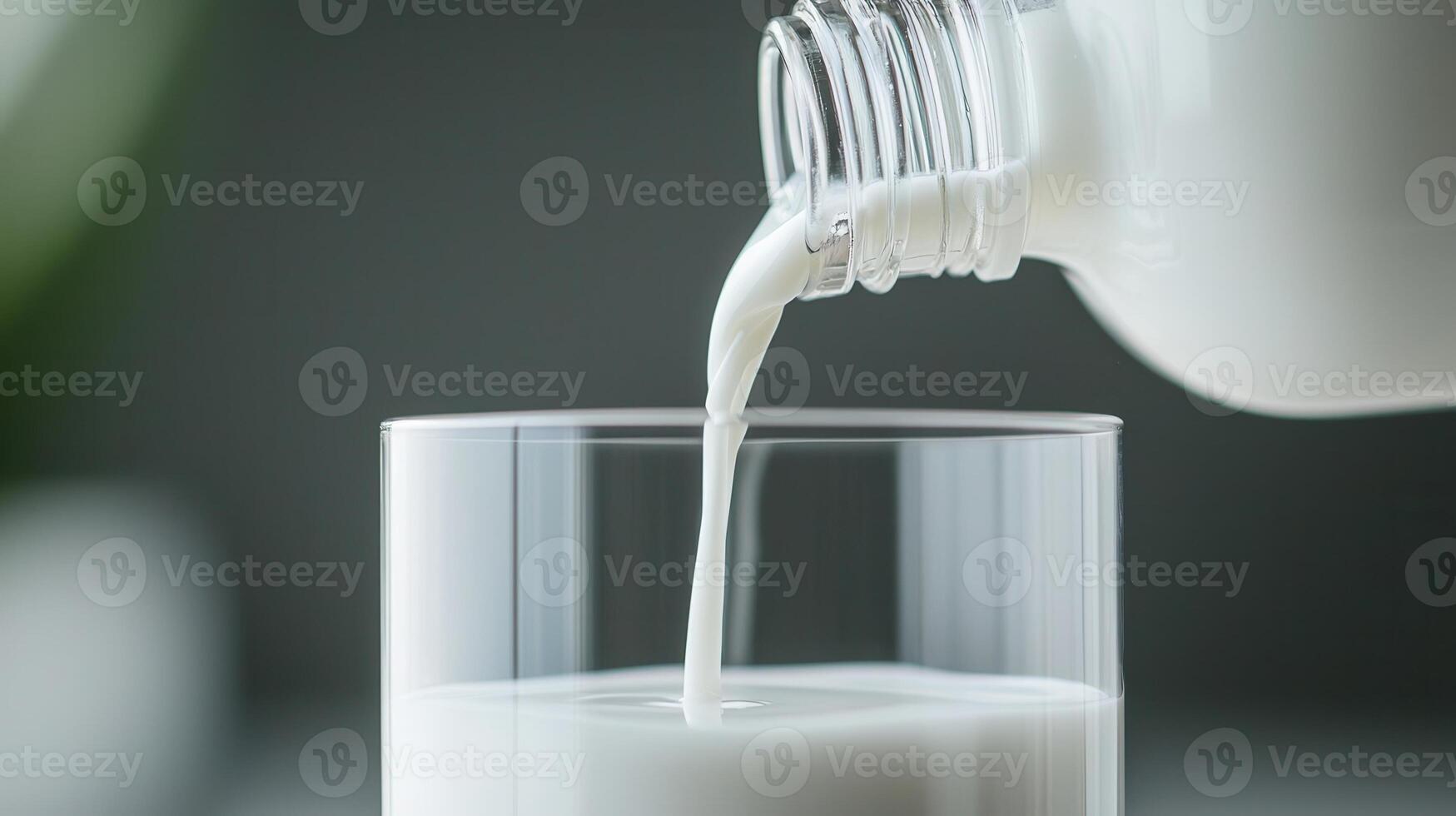 Milk streaming into glass, light frothy bubbles against dairy kitchen surface, capturing forming freshness photo