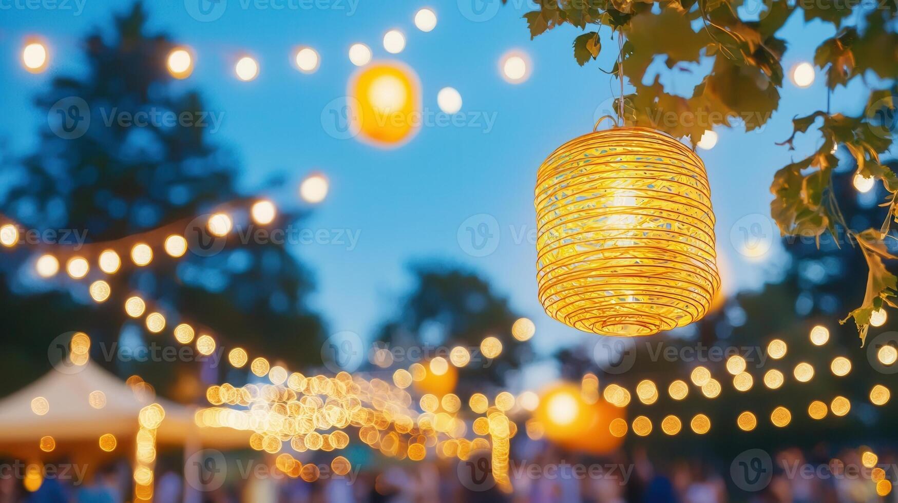 Glowing paper lanterns illuminate festive outdoor scene at dusk, creating a warm and inviting atmosphere photo