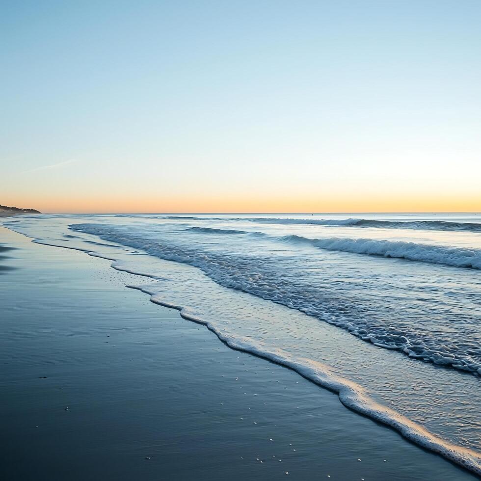 Serene Sunrise Seascape Gentle Waves Rolling Onto a Sandy Shore. photo