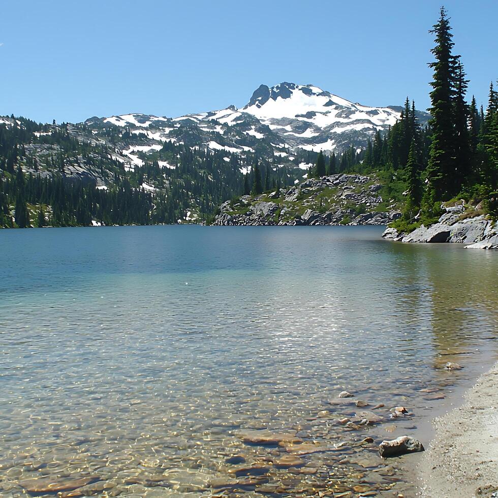 Crystal Clear Alpine Lake with Majestic Snow-capped Mountain Peak. A serene landscape photograph ideal for travel and nature publications. photo