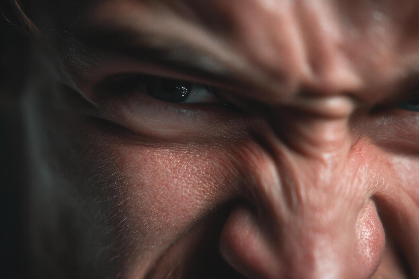 A close up of a man's face with a big angry look photo