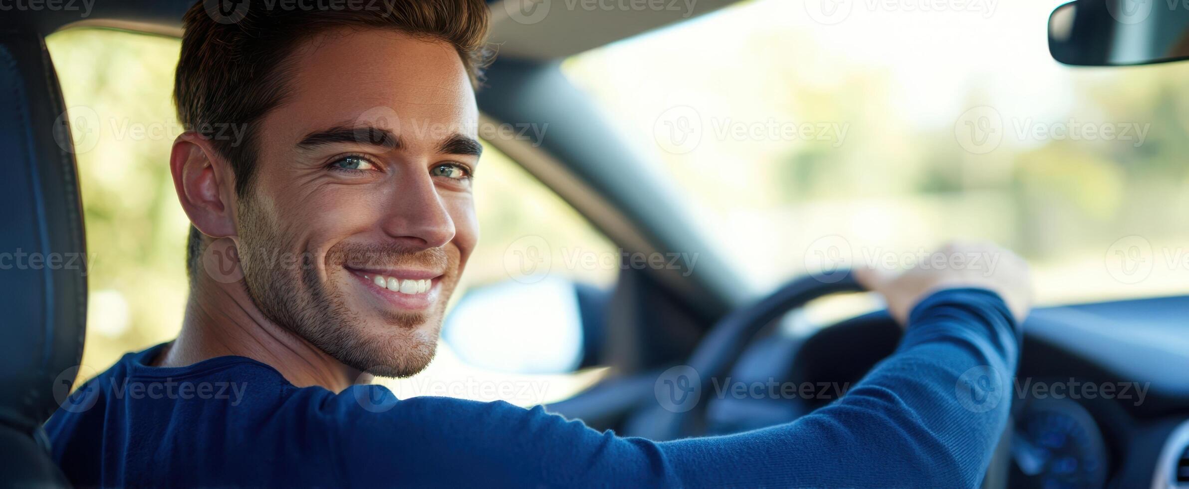 The man driving and smiling brightly in a modern car interior. photo