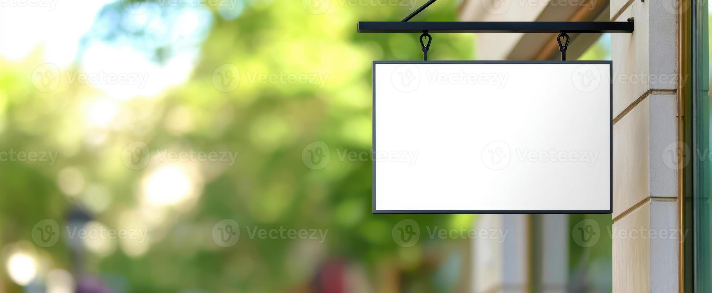 The Blank Sign Hanging Outside a Modern Storefront in a Vibrant Urban Environment photo