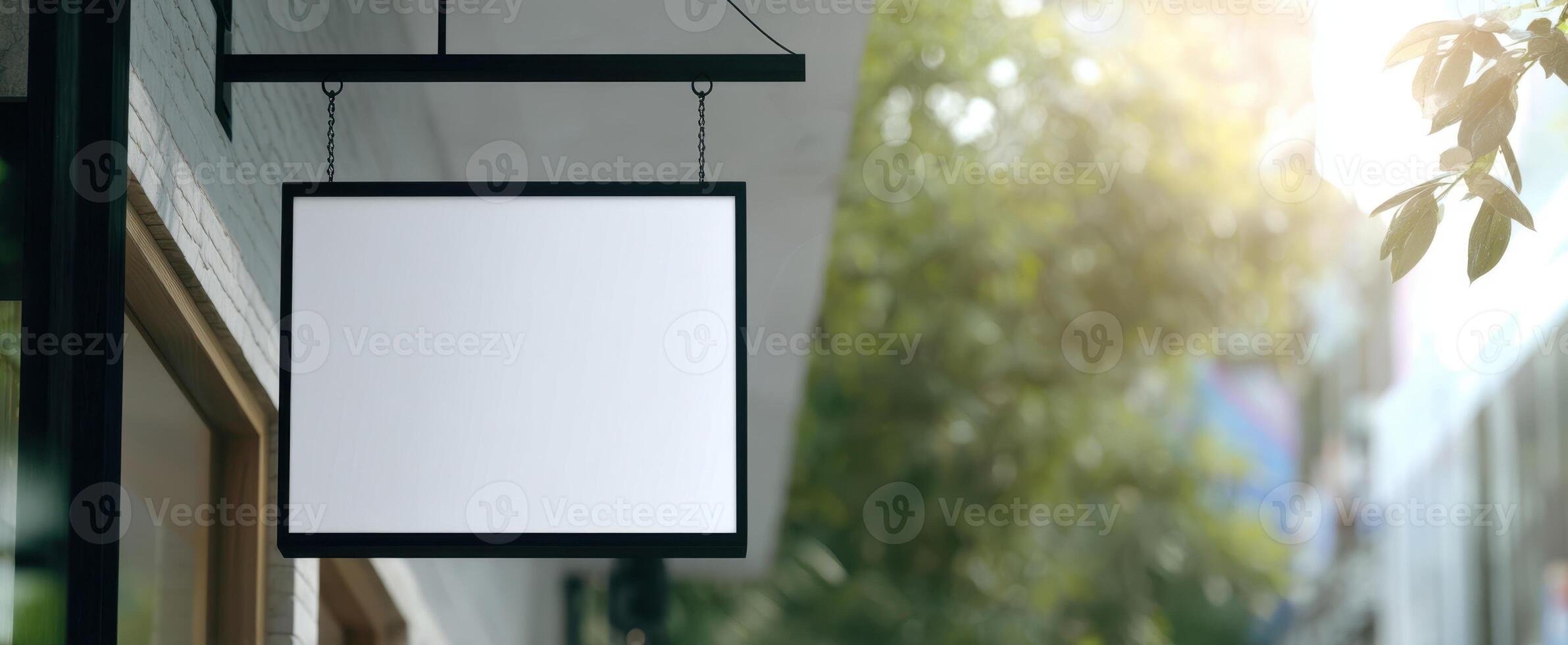 The blank sign hanging outside a modern storefront ready for customization. photo