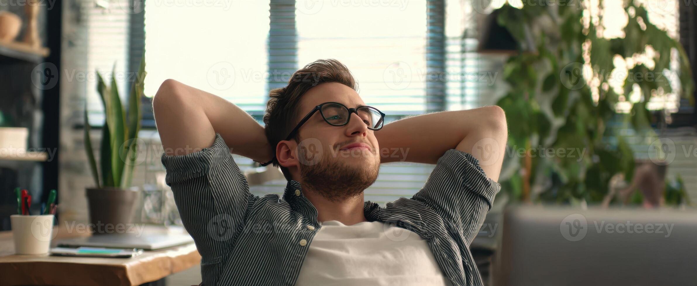The man enjoying a moment of relaxation in a modern office space. photo