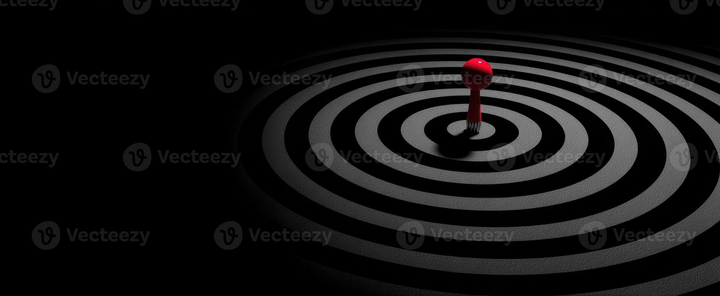 The red object in the mesmerizing black circular pattern. photo