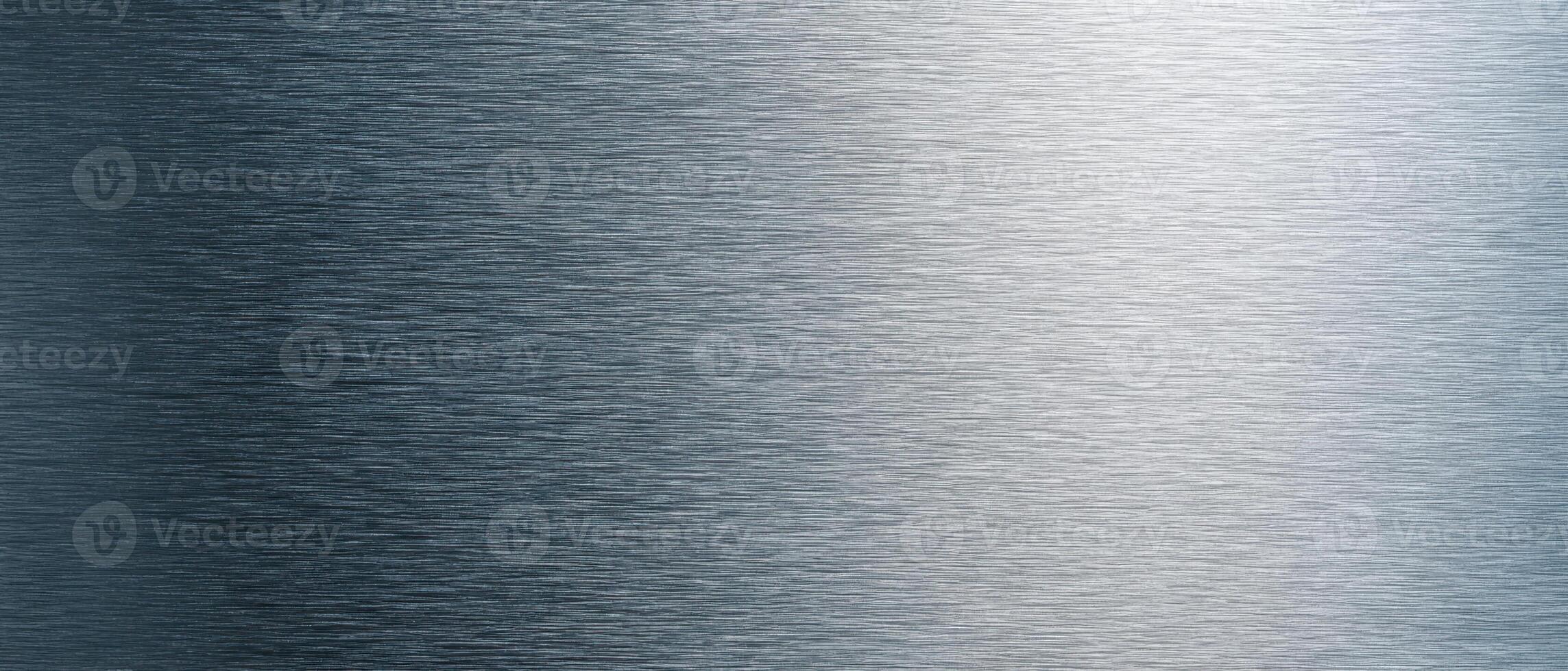 The brushed metal surface with sleek modern design and subtle reflections. photo
