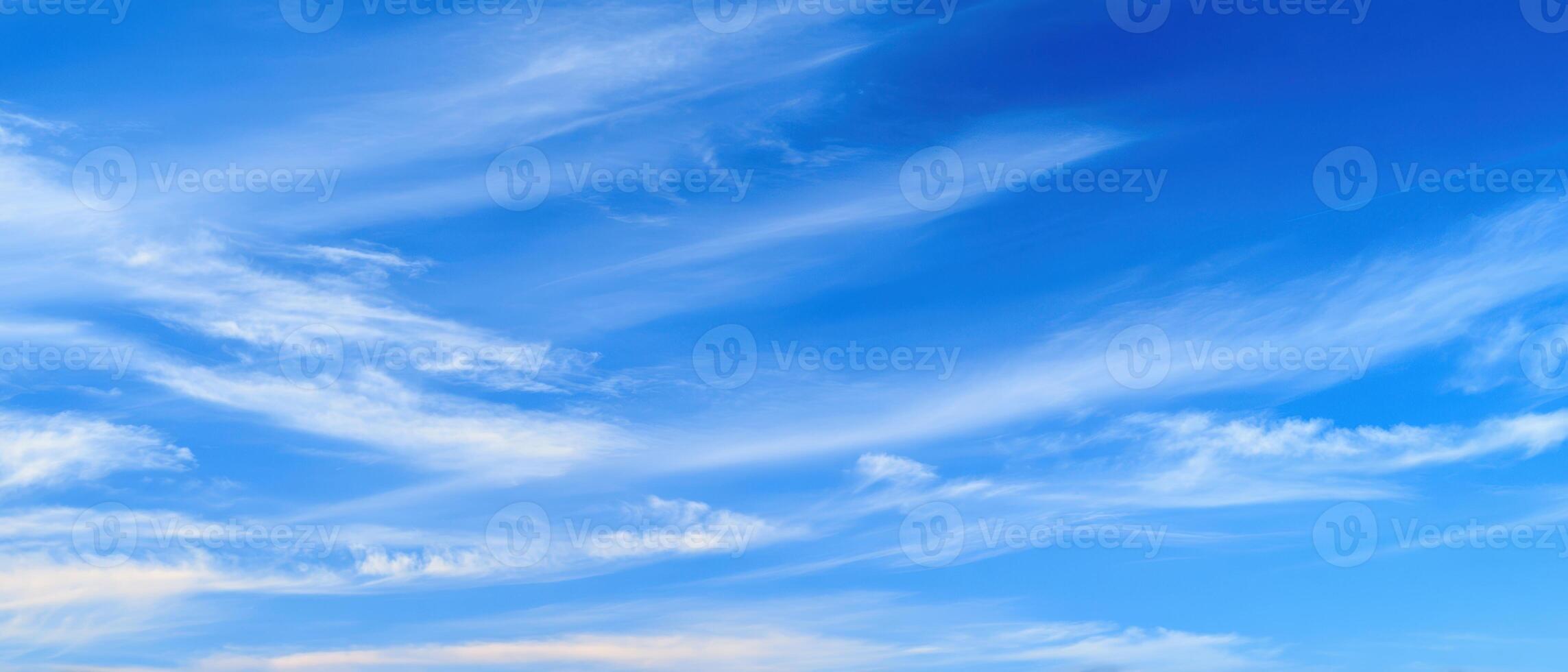 The serene blue sky with wispy clouds creates a perfect daydream backdrop. photo