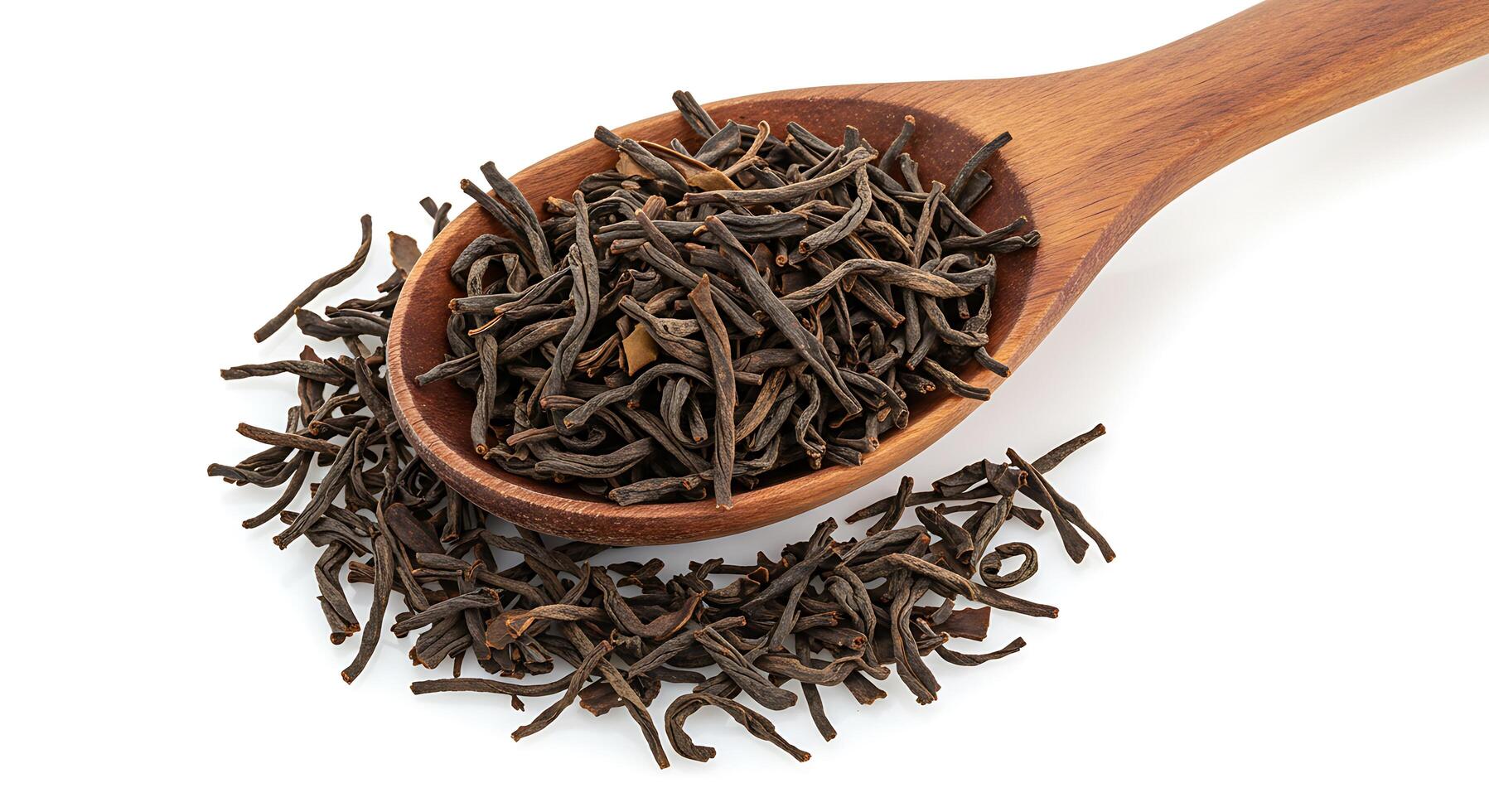 Black tea leaves in a wooden spoon photo