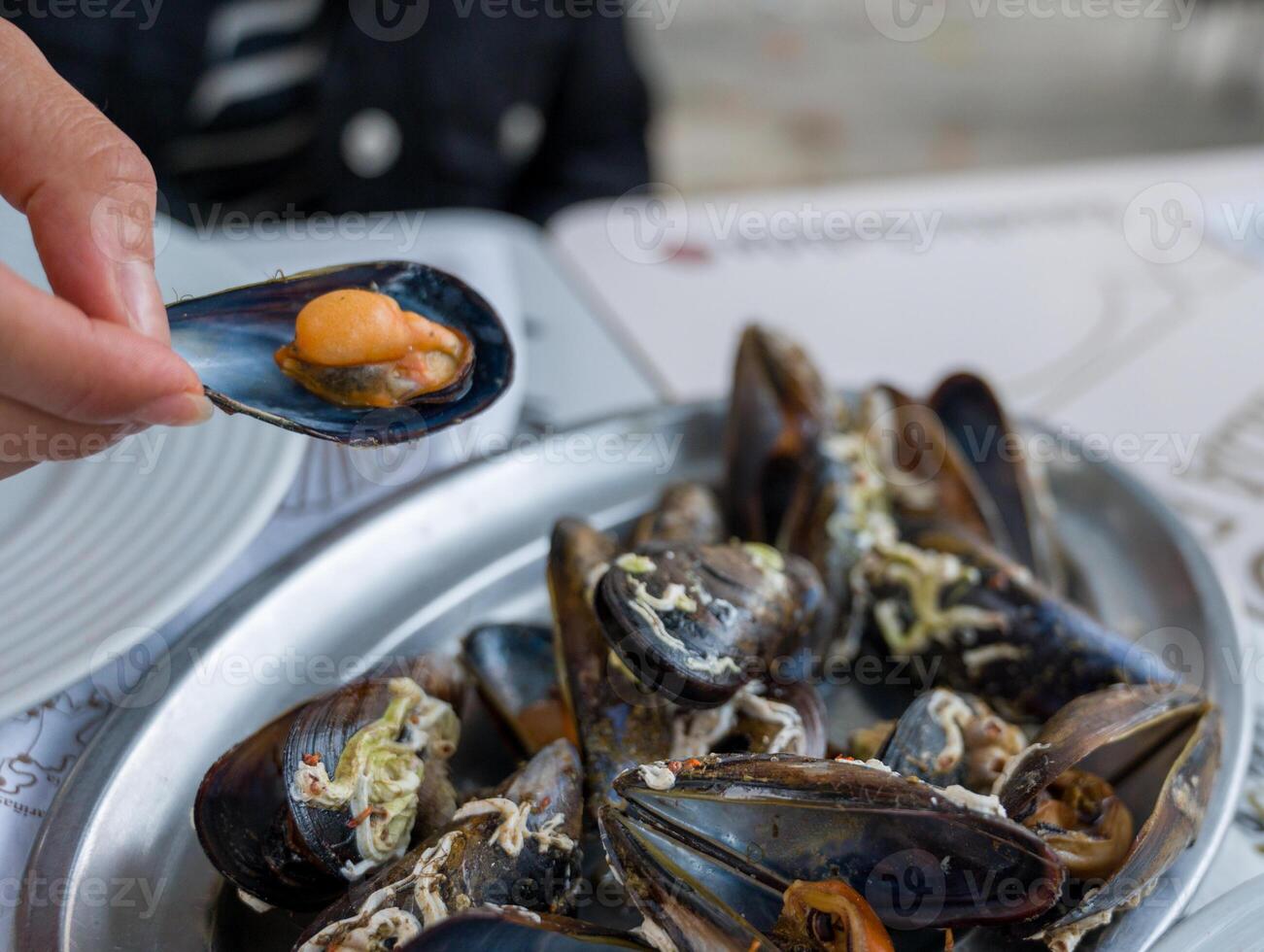 A delectable dish of fresh mussels served with a slice of lemon. photo