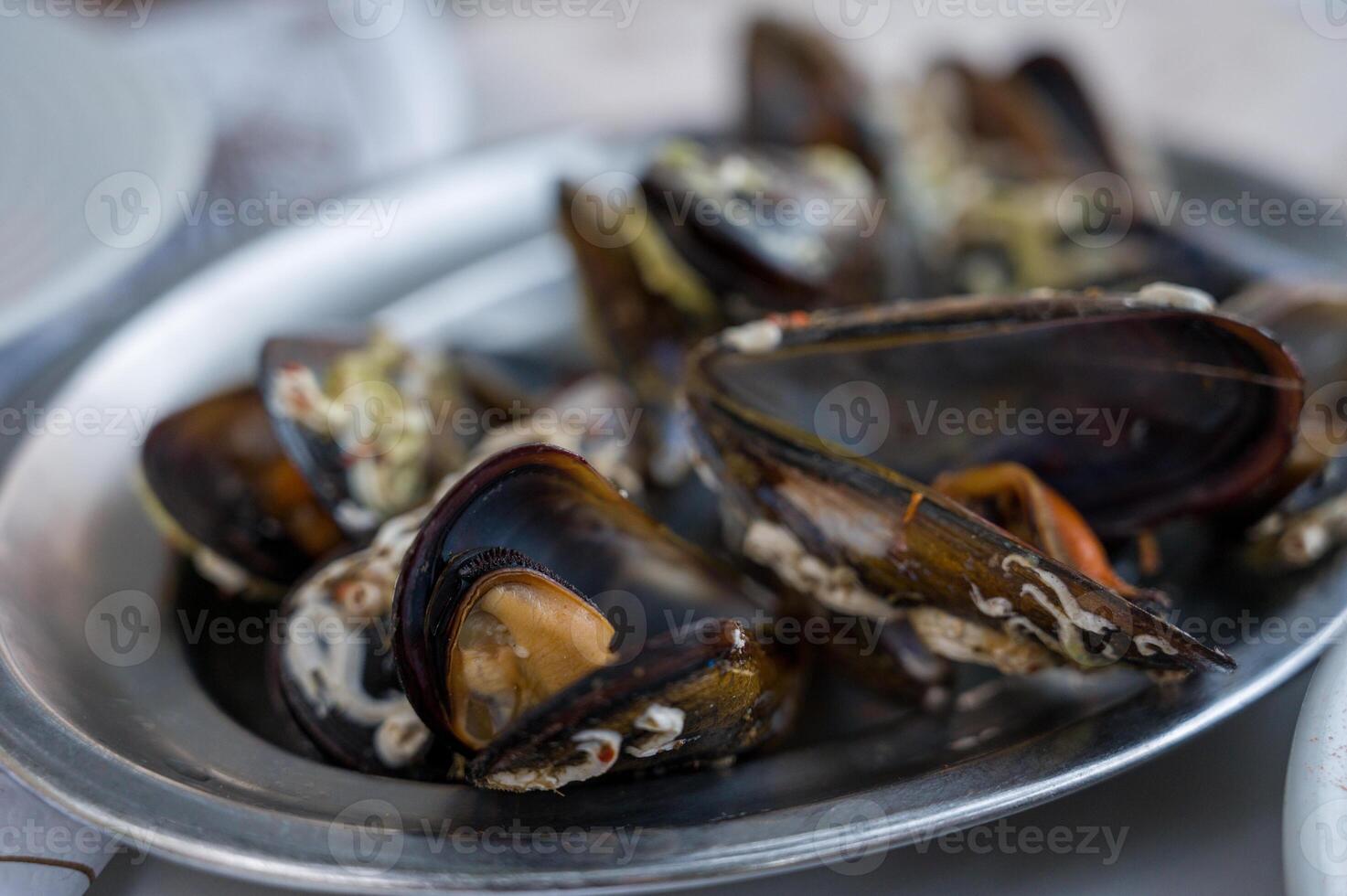 A delectable dish of fresh mussels served with a slice of lemon.. photo