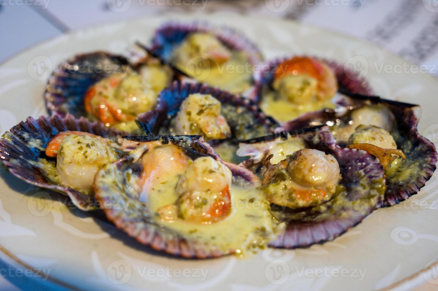 Grilled scallops with olive oil, garlic and parsley. Galician style of scallop dish Vieira. Typical Zamburinas dish from Galicia, spain, Delicious Spanish tapas food photo