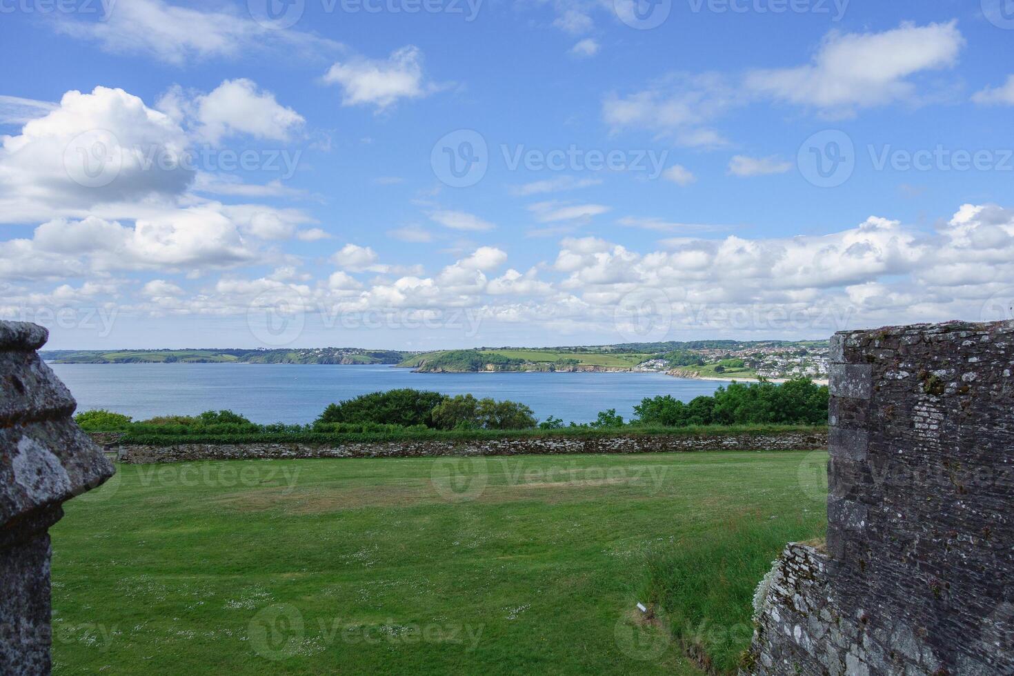 A view of a field with a kite flying in it photo